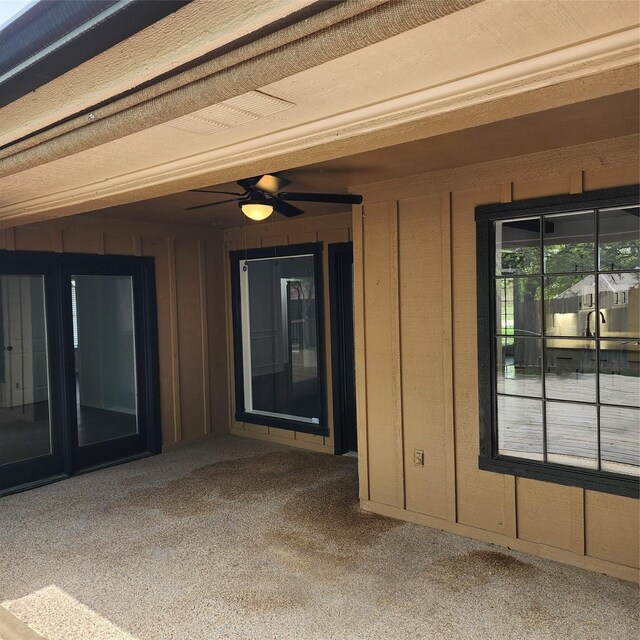 doorway to property with ceiling fan and a patio