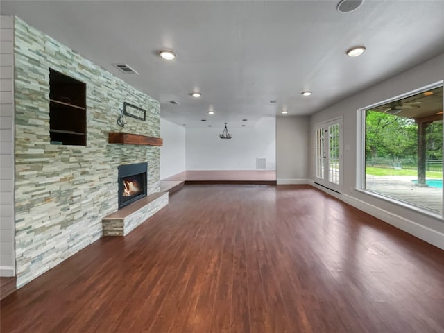 unfurnished living room with dark hardwood / wood-style flooring and a fireplace