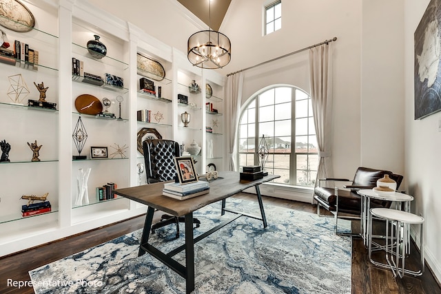 office featuring built in shelves, dark wood-type flooring, and a chandelier