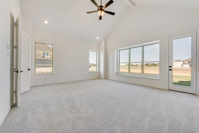 carpeted spare room with ceiling fan, beam ceiling, and high vaulted ceiling