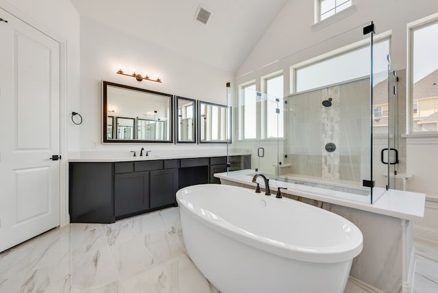 bathroom with vanity, separate shower and tub, and vaulted ceiling