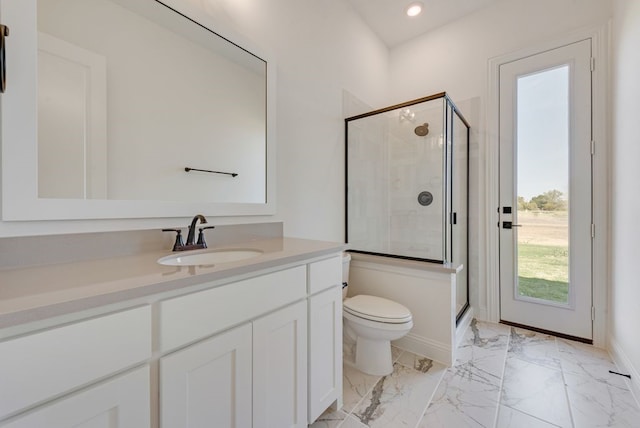 bathroom featuring vanity, a shower with shower door, and toilet