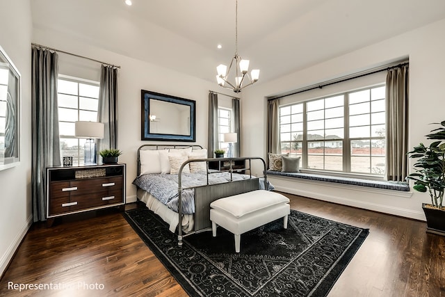 bedroom with a chandelier and dark hardwood / wood-style flooring