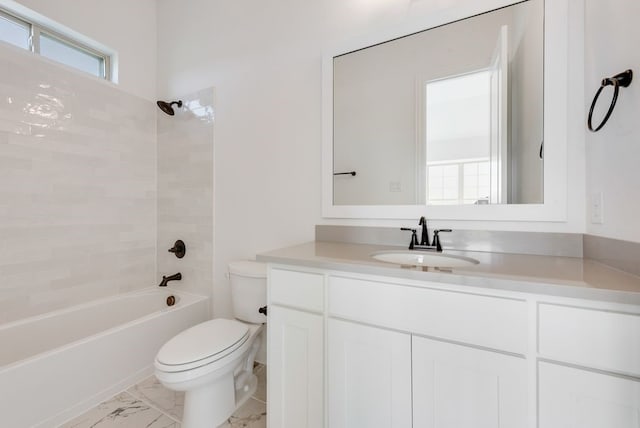 full bathroom with toilet, vanity, and tiled shower / bath