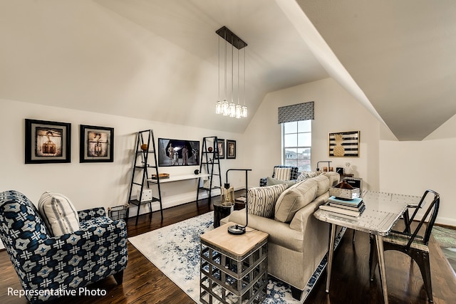 living room featuring lofted ceiling, dark wood-type flooring, and an inviting chandelier