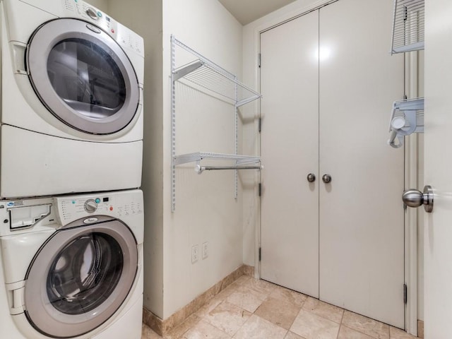 washroom with laundry area and stacked washer / drying machine