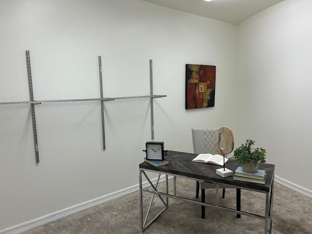 office area with baseboards and concrete floors