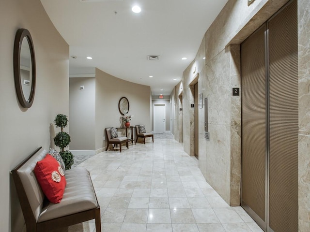 hall with elevator, visible vents, recessed lighting, and baseboards