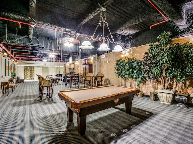 rec room featuring brick wall, carpet, visible vents, and pool table