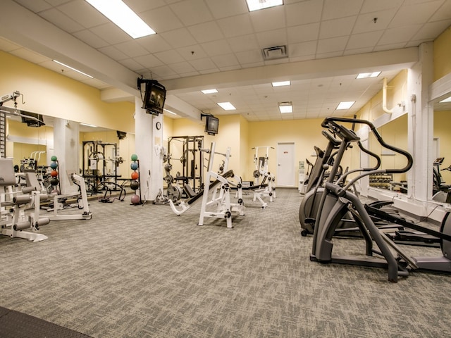 workout area with carpet and a drop ceiling