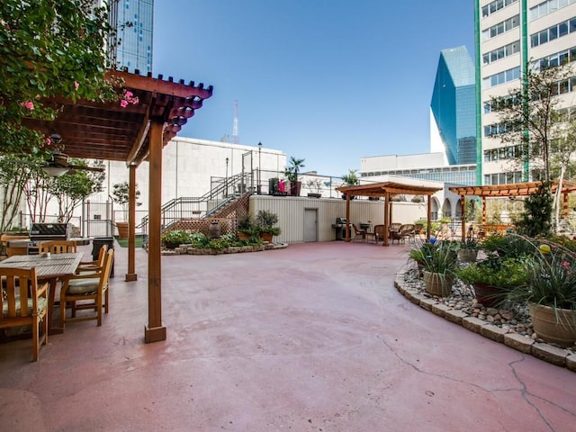 view of patio featuring outdoor dining space, area for grilling, fence, and a pergola