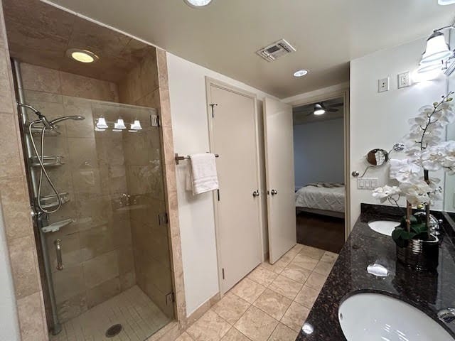 bathroom with vanity, ceiling fan, tile patterned floors, and walk in shower