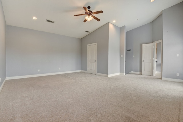 spare room with light carpet, ceiling fan, and lofted ceiling