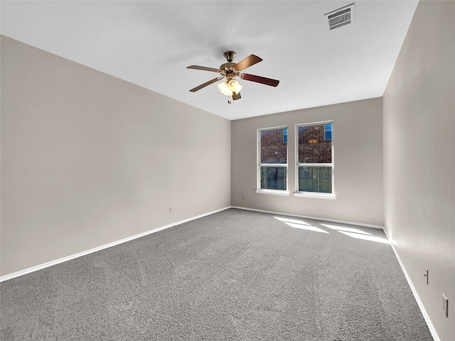 carpeted spare room featuring ceiling fan