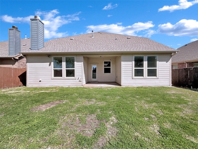 rear view of house featuring a patio and a yard