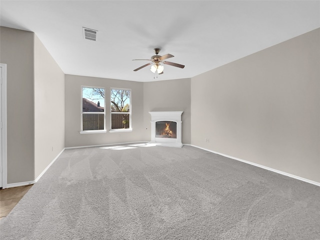 unfurnished living room with ceiling fan and light colored carpet