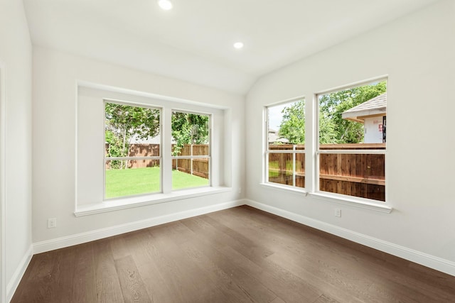 spare room featuring recessed lighting, dark wood-style flooring, and baseboards