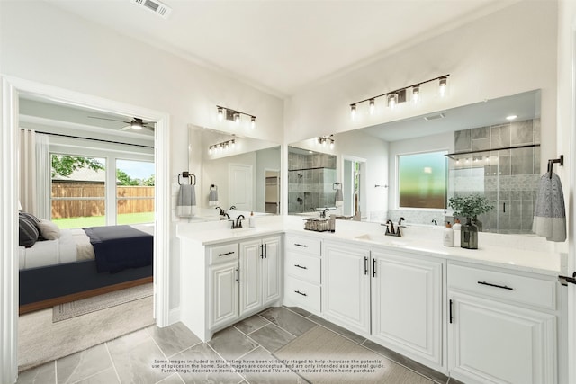 bathroom with visible vents, a sink, a shower stall, and double vanity