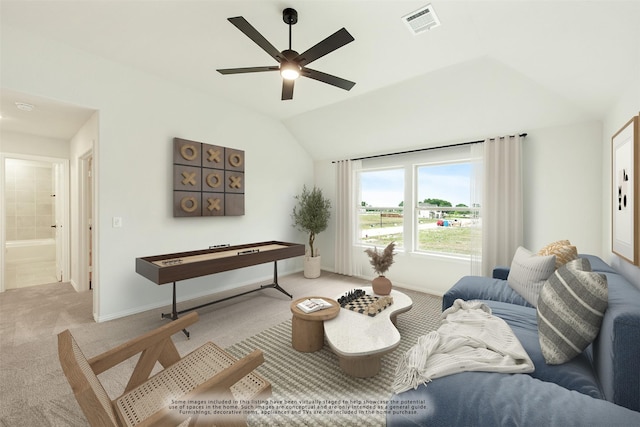 living room with baseboards, visible vents, light colored carpet, ceiling fan, and vaulted ceiling