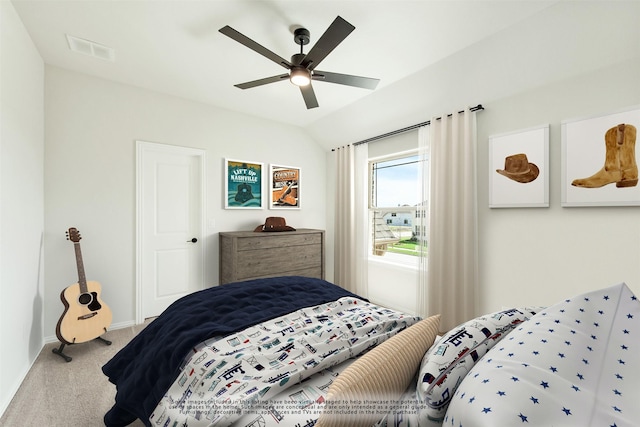 carpeted bedroom with ceiling fan, visible vents, vaulted ceiling, and baseboards