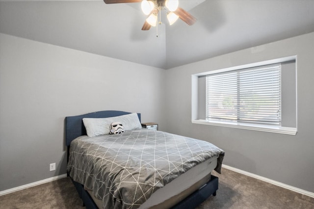 bedroom with ceiling fan, dark carpet, and vaulted ceiling