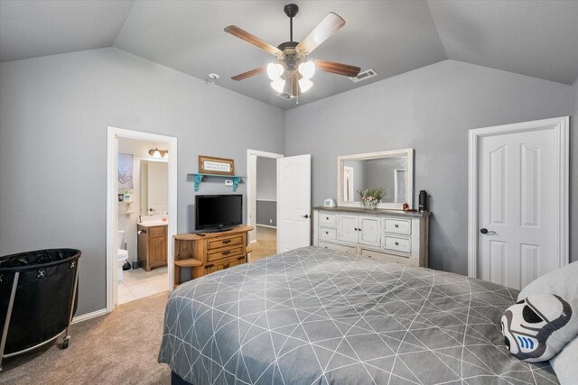 bedroom with carpet flooring, ensuite bathroom, ceiling fan, and lofted ceiling