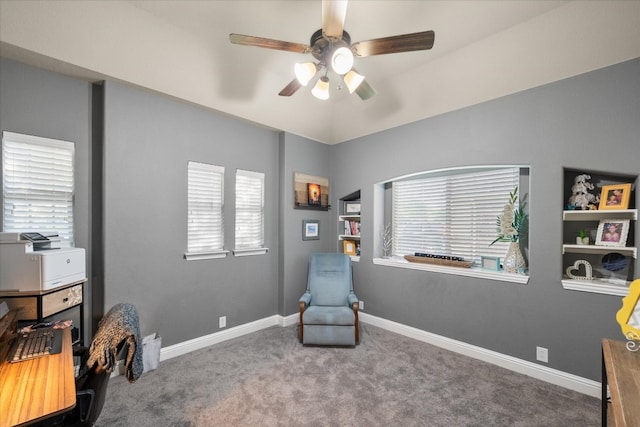 living area featuring carpet and ceiling fan