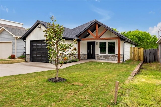 view of front of house featuring a garage and a front lawn