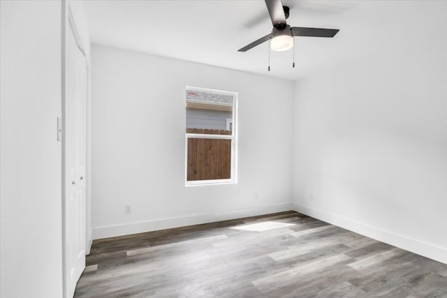 unfurnished room with ceiling fan and dark hardwood / wood-style floors