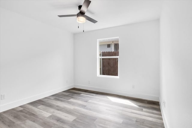 empty room with ceiling fan and light wood-type flooring