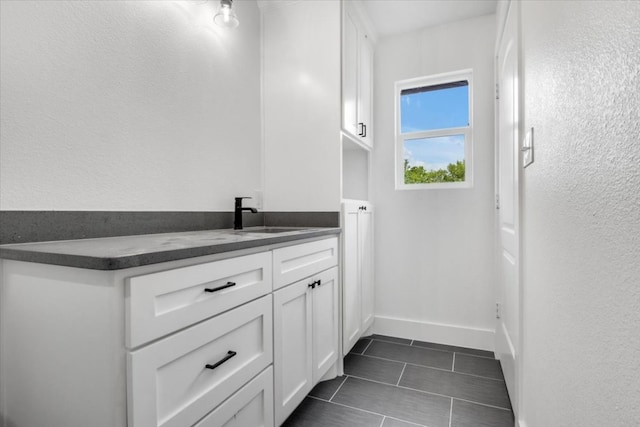 bathroom with tile flooring and sink