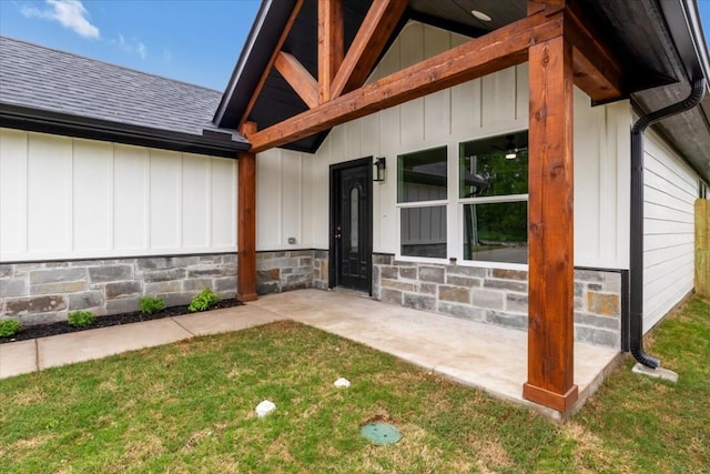 doorway to property featuring a lawn