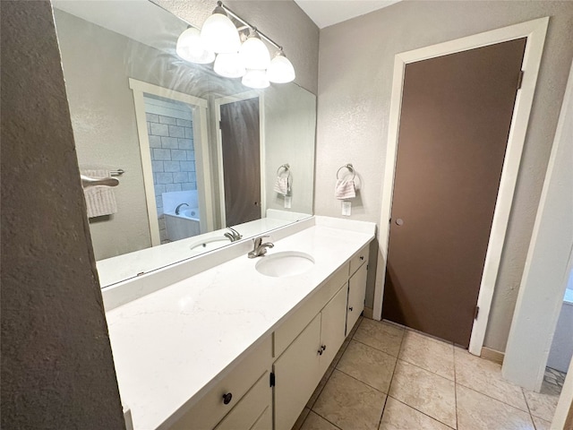 bathroom featuring a tub, tile floors, and large vanity