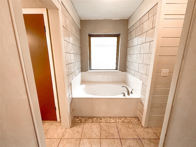 bathroom featuring tile floors and a tub