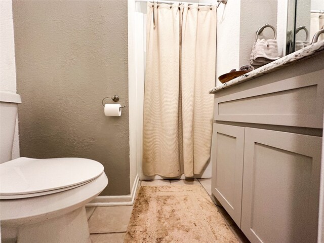 bathroom with tile flooring and toilet