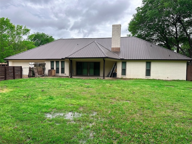 back of property with a patio and a lawn