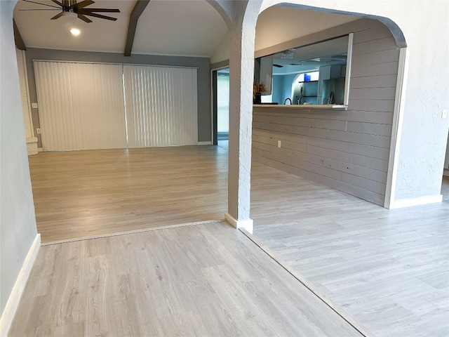 hallway with light wood-type flooring and beamed ceiling