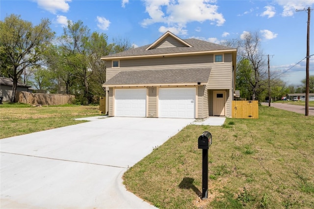 view of front of home featuring a front lawn and a garage