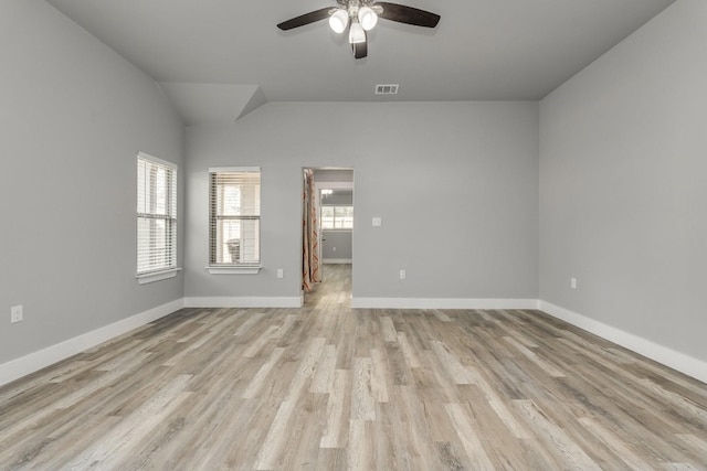 unfurnished room with ceiling fan, light wood-type flooring, and vaulted ceiling