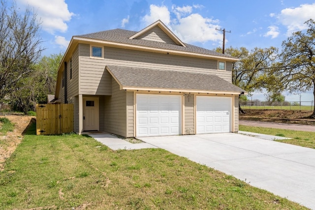 view of property with a front lawn and a garage