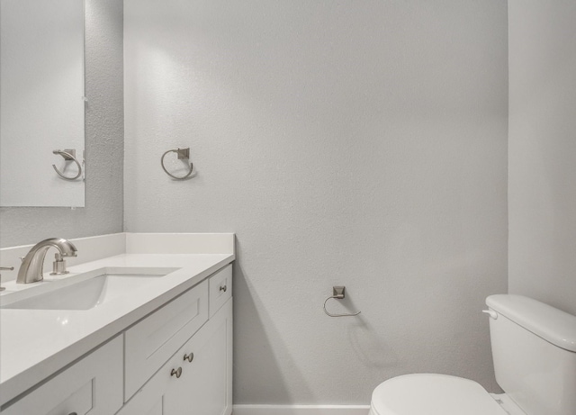 bathroom featuring toilet and large vanity