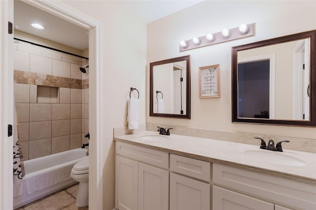 full bathroom with toilet, tile patterned floors, vanity, and shower / tub combo with curtain