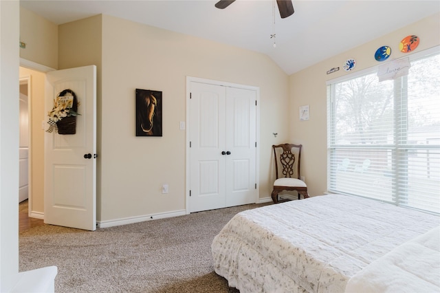 bedroom featuring carpet floors, a closet, vaulted ceiling, ceiling fan, and baseboards