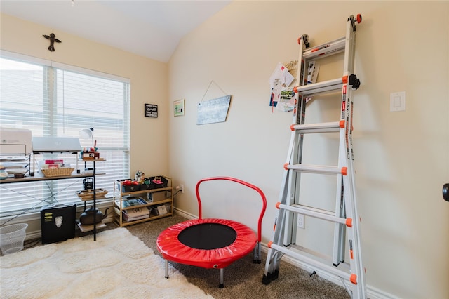 recreation room featuring carpet flooring and vaulted ceiling