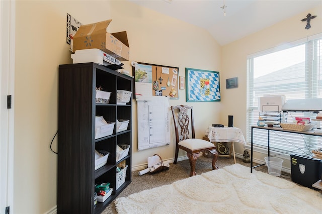 living area with carpet, baseboards, and vaulted ceiling