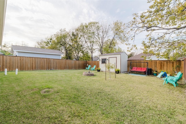 view of yard with a fire pit and a storage shed