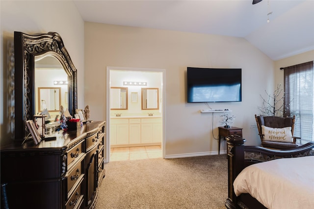 bedroom with light carpet, connected bathroom, lofted ceiling, and sink