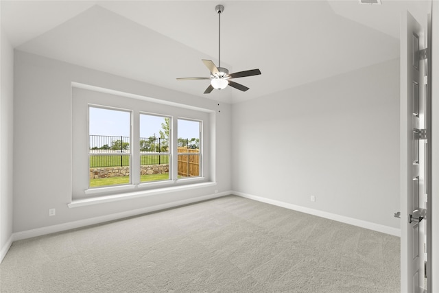 carpeted empty room featuring ceiling fan