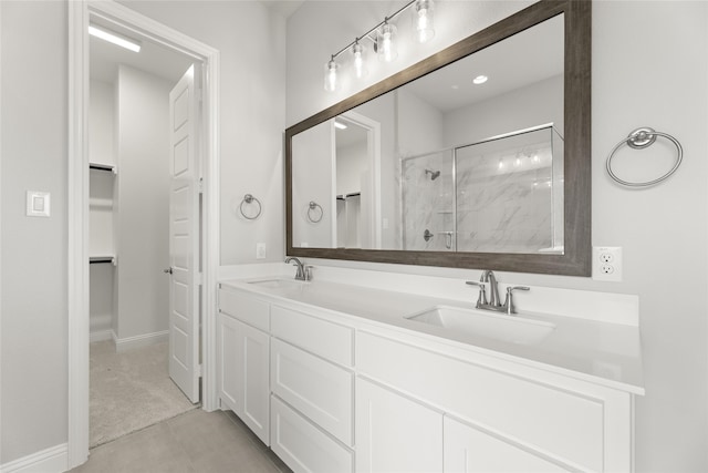 bathroom featuring tile patterned flooring, vanity, and walk in shower