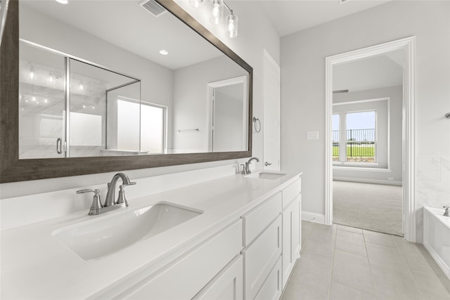 bathroom featuring vanity, shower with separate bathtub, and tile patterned flooring